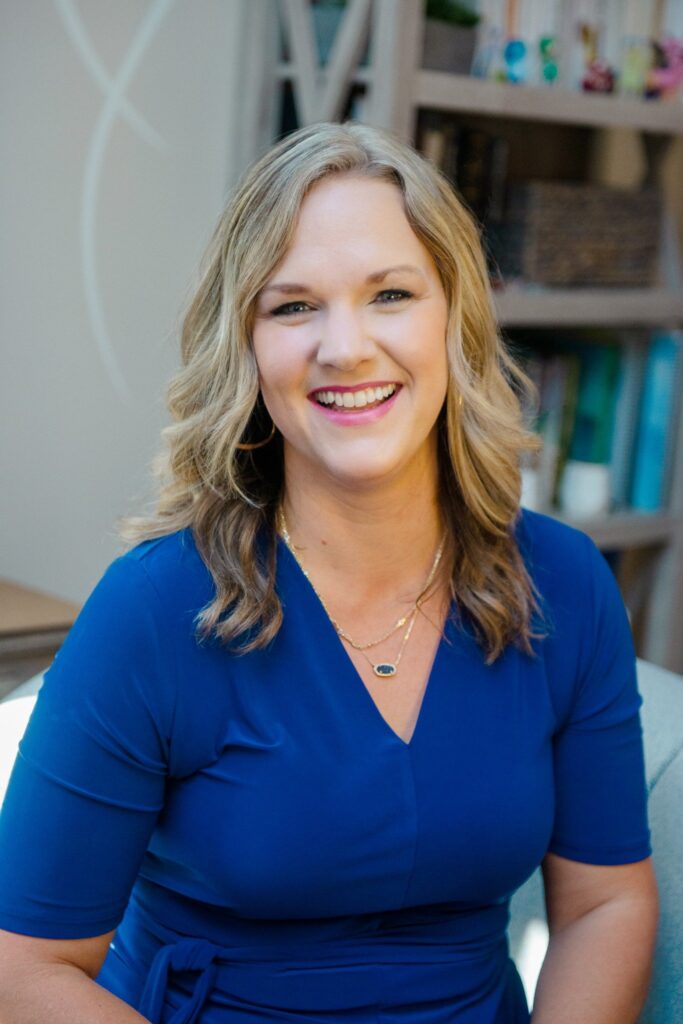 Therapist Bonnie Lewis seated indoors facing camera.