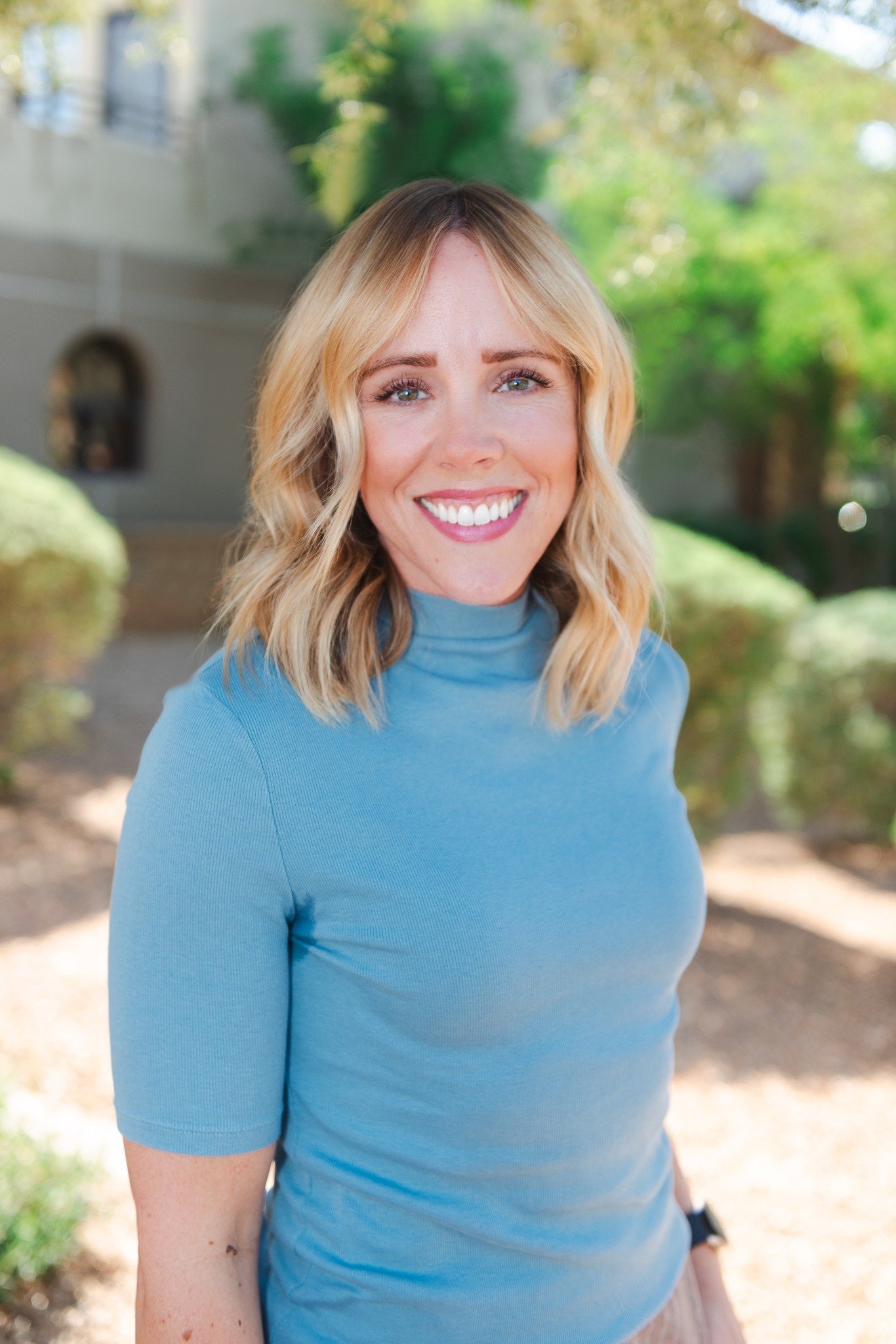 Therapist Chelsea Francis standing outside in a blue sweater.